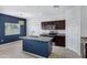 Modern kitchen featuring a center island, stainless steel appliances, and a view into the living space at 2540 E Atlanta Ave, Phoenix, AZ 85040