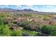 Aerial view featuring tennis courts, swimming pool, and golf course, surrounded by lush greenery at 26764 W Ponderosa Ln, Buckeye, AZ 85396