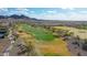 Golf course with manicured greens and sand traps, set against a backdrop of mountains at 26764 W Ponderosa Ln, Buckeye, AZ 85396