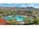 Aerial view showcasing the community pool, surrounded by palm trees, with mountain views in the distance at 26764 W Ponderosa Ln, Buckeye, AZ 85396