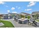 Outdoor kitchen with built-in grill and firepit featuring Adirondack chairs for entertaining in the backyard at 26764 W Ponderosa Ln, Buckeye, AZ 85396