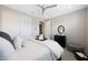 Bright bedroom with white walls, a ceiling fan, and dark wood accents for a modern look at 26764 W Ponderosa Ln, Buckeye, AZ 85396