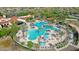 Aerial view of a large community pool with lap lanes, leisure areas, and surrounding palm trees at 26764 W Ponderosa Ln, Buckeye, AZ 85396