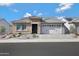 Charming single-story home with stone accents, tile roof, a two-car garage, and professionally landscaped front yard at 26764 W Ponderosa Ln, Buckeye, AZ 85396