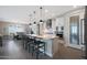 Bright, open kitchen featuring white cabinetry, an island with seating, and stainless steel appliances at 26764 W Ponderosa Ln, Buckeye, AZ 85396