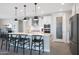 Modern kitchen featuring white cabinets, a large island with seating, and stainless steel appliances at 26764 W Ponderosa Ln, Buckeye, AZ 85396