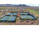 Aerial image of tennis courts with manicured landscaping, showcasing a vibrant community amenity at 26764 W Ponderosa Ln, Buckeye, AZ 85396