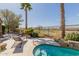 Beautiful backyard featuring a plunge pool, lounge chairs, mature trees, and views of the nearby golf course at 29390 N 128Th Ln, Peoria, AZ 85383