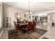 Dining area with a rustic wood table and views into the kitchen and living spaces at 29390 N 128Th Ln, Peoria, AZ 85383