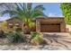 Charming home exterior with a brick facade, a well-manicured yard, and desert landscaping at 29390 N 128Th Ln, Peoria, AZ 85383