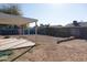 Exterior backyard space with covered patio and graffiti-covered walls and fence at 3227 W Villa Rita Dr, Phoenix, AZ 85053