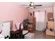 A bedroom featuring a window with white drapes and boxes stored near a chair at 3227 W Villa Rita Dr, Phoenix, AZ 85053