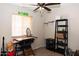 Bedroom featuring a ceiling fan, a desk, and closet space at 3227 W Villa Rita Dr, Phoenix, AZ 85053