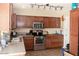 Traditional kitchen showcasing stainless steel appliances, granite countertops, and a tiled floor at 3227 W Villa Rita Dr, Phoenix, AZ 85053