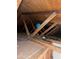 Close-up of the attic's wooden beams with some wiring, highlighting the building's robust construction at 3452 E Evans Dr, Phoenix, AZ 85032