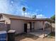 Backyard view showing covered patio, exterior refrigerator, and block wall at 3452 E Evans Dr, Phoenix, AZ 85032