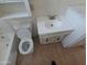 Bathroom featuring a white toilet, vanity with a sink, and wood-look flooring at 3452 E Evans Dr, Phoenix, AZ 85032