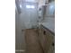 Bathroom with white tile, white vanity, and shower over tub at 3452 E Evans Dr, Phoenix, AZ 85032