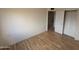 Comfortable bedroom with hardwood floors, white walls, and closet at 3452 E Evans Dr, Phoenix, AZ 85032