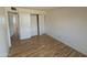 Empty bedroom featuring wood-look floors, a closet with sliding doors and ample space at 3452 E Evans Dr, Phoenix, AZ 85032