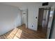 Empty bedroom features wood-look floors, closet with folding doors and natural lighting at 3452 E Evans Dr, Phoenix, AZ 85032