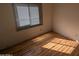 Bright bedroom with wood floors and window with blinds at 3452 E Evans Dr, Phoenix, AZ 85032