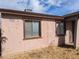 Exterior wall of home with windows and peeling stucco at 3452 E Evans Dr, Phoenix, AZ 85032