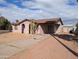 A quaint single-story home with a covered porch and a xeriscaped yard, showcasing curb appeal at 3452 E Evans Dr, Phoenix, AZ 85032