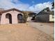 View of the exterior with stucco siding and a covered carport and xeriscape at 3452 E Evans Dr, Phoenix, AZ 85032