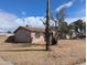 Shot of a stucco-sided home with desert-friendly landscaping and mature trees surrounding the property at 3452 E Evans Dr, Phoenix, AZ 85032