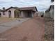 Cozy home with a covered carport and low-maintenance landscaping, situated on a gravel lot at 3452 E Evans Dr, Phoenix, AZ 85032