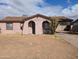 Exterior of a cozy single-story home with a desert landscape and arched entryway at 3452 E Evans Dr, Phoenix, AZ 85032