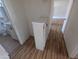 Hallway view with laminate floors, bathroom, and white linen cabinet at 3452 E Evans Dr, Phoenix, AZ 85032