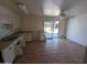 Kitchen with laminate floors, ceiling fan, white cabinets, and sliding glass doors to the yard at 3452 E Evans Dr, Phoenix, AZ 85032