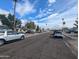 Street view with multiple cars parked in front of houses surrounded by mature trees at 3452 E Evans Dr, Phoenix, AZ 85032