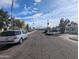 Street view with multiple cars parked in front of houses surrounded by mature trees at 3452 E Evans Dr, Phoenix, AZ 85032