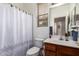 Bathroom featuring a sink with wood cabinet, a toilet and a shower with a white pattern curtain at 3588 S 257Th Ave, Buckeye, AZ 85326