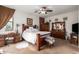 Cozy bedroom with a ceiling fan, plush carpet and classic wood furniture at 3588 S 257Th Ave, Buckeye, AZ 85326