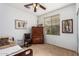 Bedroom with wooden furniture, a window, and decorative items on the walls at 3588 S 257Th Ave, Buckeye, AZ 85326