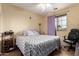 Bedroom with ceiling fan, window with blinds and a comfortable bed with patterned bedding at 3588 S 257Th Ave, Buckeye, AZ 85326