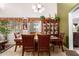 Inviting dining room with classic wood furniture, chandelier, and decorative display case at 3588 S 257Th Ave, Buckeye, AZ 85326