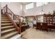 Living room featuring high ceilings, a staircase, and a dining table at 3588 S 257Th Ave, Buckeye, AZ 85326