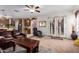 Living room featuring plush seating, a ceiling fan, and access to the kitchen at 3588 S 257Th Ave, Buckeye, AZ 85326