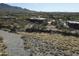 Wide aerial shot of the home nestled among desert landscaping and mountainous terrain, offering privacy and seclusion at 36102 N Creek View Ln, Cave Creek, AZ 85331