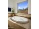 Soaking tub with picturesque window views of the natural landscape at 36102 N Creek View Ln, Cave Creek, AZ 85331