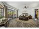 Tranquil bedroom with wood floors, a sliding glass door to the backyard, and a ceiling fan providing comfort and style at 36102 N Creek View Ln, Cave Creek, AZ 85331