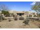 Southwestern home features neutral colors, an inviting courtyard entrance, desert landscaping, and mature foliage at 36102 N Creek View Ln, Cave Creek, AZ 85331