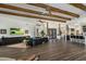 Spacious living area featuring wood beam ceilings, a wet bar, and an open layout at 36102 N Creek View Ln, Cave Creek, AZ 85331