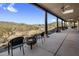 Extended covered patio with a fire pit and seating provides outdoor relaxation with mountain views at 36102 N Creek View Ln, Cave Creek, AZ 85331