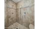 Walk-in shower with natural stone tiles and multiple shower heads at 36102 N Creek View Ln, Cave Creek, AZ 85331